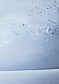 Young male snowboarder riding through deep powder snow in the mountains, Pitztal, Tyrol, Austria