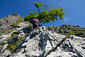 Woman climbing the Via ferrata del Centenario, Italy and Switzerland