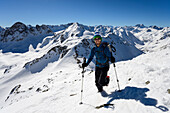 Mountaineer shortly before the summit of the Schwarzhorn (3146 m), summits in the background from left to right: Piz Radönt, Radüner Rothorn, Piz Palü, Piz Bernina, Piz Morteratsch, Piz Rosatsch, Piz Kesch, Grisons, Switzerland, Europe