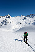 Ski-tourer in front of the Grialetsch area with Grialetsch Glacier, Piz Sarsura (right hand, 3178 m) and Piz Sarsura Pitschen left hand (3134 m), Grisons, Switzerland, Europe