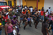 Women in costume dance in street at parade celebrating begin of carnival season, St. John's, St. John, Antigua, Antigua and Barbuda