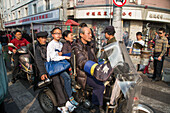 Family on motorized rickshaw in Old Town (Nanshi), Shanghai, China