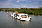 River cruise ship Viking Lif (Viking River Cruises) on Main river and Maria im Weingarten pilgrimage church, Volkach, Franconia, Bavaria, Germany