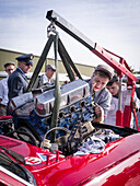 Mechanics changing the engine of a Ford Mustang, Goodwood Revival 2014, Racing Sport, Classic Car, Goodwood, Chichester, Sussex, England, Great Britain