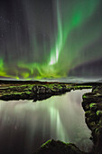 Reflection of northern lights aurora borealis in Thingvallavatn lake, National Park Thingvellir, UNESCO world heritage, Golden Circle, Southern Iceland, Iceland, Europe