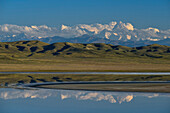 Reflection of tallest Tien Shan peaks among them Khan Tengri and Peak Pobeda and steppe mountains in front of them, Tuzkoel Salt Lake, Tuzkol, Tien Shan, Tian Shan, Almaty region, Kazakhstan, Central Asia, Asia