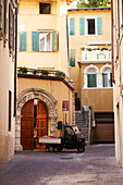 Ape pickup passing the old town, Arco, Trentino, Italy