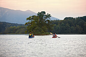 Family canoe touring on lake Staffelsee, Seehausen, Upper Bavaria, Germany