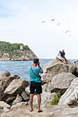 tourists taking pictures at the beach of Portals Vells, near Magaluf, Majorca, Balearic Islands, Mediterranean Sea, Spain, Europe