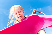 5 year old girl on a water slide, harbour, MR, Port de Soller, Serra de Tramuntana, Majorca, Balearic Islands, Spain, Europe