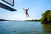 Girl jumping from a tower, Swimming baths at lake Diek, Malent, Holstein Switzerland, Ostholstein, Schleswig-Holstein, Germany