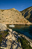 Anchoring sailing yacht in a lonely bay on the greek island Syphnos  (Sifnos), Aegean, Cyclades, Greece