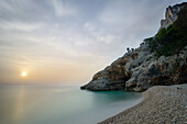 Sunrise at the pebble beach of the bay Cala Sisine, Selvaggio Blu, Sardinia, Italy, Europe