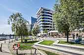 People sitting at Dalmannkai in Hafencity, Hamburg, Germany