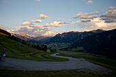 Junge Fahrradfahrerin macht eine Pause um die Umgebung zu genießen, Tannheimer Tal, Tirol, Österreich