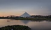 Fisherman in his boat, Mayon volcano in the background, Legazpi, Philippines, Asia