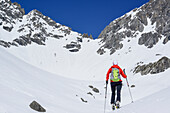 Woman back-country skiing ascending towards Scharnitzsattel, Scharnitzsattel, Lechtal Alps, Tyrol, Austria