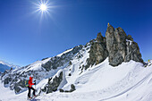 Woman back-country skiing ascending towards Scharnitzsattel, Scharnitzsattel, Lechtal Alps, Tyrol, Austria