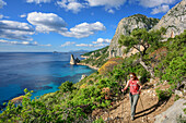 Woman hiking Selvaggio Blu, view towards Pedra Longa, Selvaggio Blu, National Park of the Bay of Orosei and Gennargentu, Sardinia, Italy