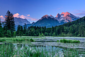 Mountain lake in front of Watzmann and Hochkalter in alpenglow, Berchtesgaden, Berchtesgaden Alps, Upper Bavaria, Bavaria, Germany