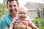 Caucasian father holding baby outdoors, Los Angeles, California, USA