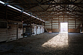 Light streaming into barn from open doorway, Nampa, Idaho, USA