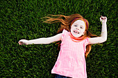 Caucasian girl laying in grass, Norfolk, Virginia, USA