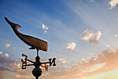 Weather vane overlooking sunbeams and clouds, C1