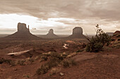 Rock formations in desert under cloudy sky, Monument Valley, Utah, United States, Monument Valley, Utah, USA
