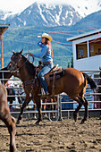 Caucasian cowgirl riding horse in rodeo on ranch, Joseph, Oregon, USA