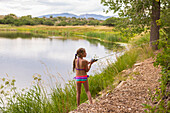 Caucasian girl fishing in rural lake, Hesperus, Colorado, USA