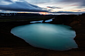 Volcanic crate pool in rock formations under sunset sky, Myvatn, Iceland, Iceland