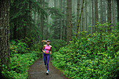 Caucasian woman running on remote path, Bainbridge Island, Wa, USA