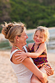 Caucasian mother and daughter enjoying the beach, Kauai, Hawaii, USA