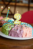 Close up of birthday cake with number two candle, Charlottesville, VA, USA