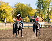 Caucasian mother and son riding horses on ranch, Jospeh, Oregon, USA
