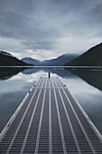 Metal pier over still remote lake, Olympic National Park, Washington, USA