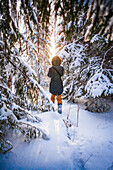 Caucasian woman walking in snowy forest, C1