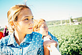 Close up of Caucasian brother and sister admiring farm, Omaha, Nebraska, USA