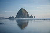 Haystack Rock reflecting in ocean, Cannon Beach, Oregon, United States, Cannon Beach, Oregon, USA