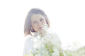 romantic young girl holding flowers outdoor