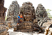 Couple visiting ancient temple, Angkor, Siem Reap, Cambodia