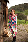 Woman wrapped in blanket outdoors