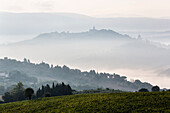 Morning fog over hills and town, Todi, Umbria, Italy