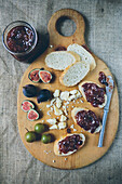 Figs and Bread with Fig Jam on Cutting Board, High Angle View