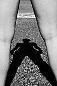 Shadow of Women Between Two Legs on Beach