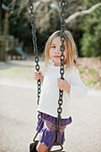 Young Girl Standing on Swing