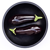 Two Eggplants in Round Bowl, High Angle View