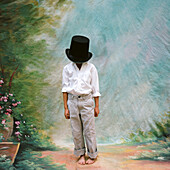 Young Boy with Large Top Hat Covering Face