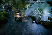Long Exposure of Bare Feet in and out of Mountain Stream